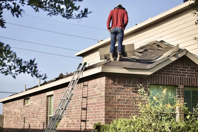 Professional roofer working on a residential roof in Bear